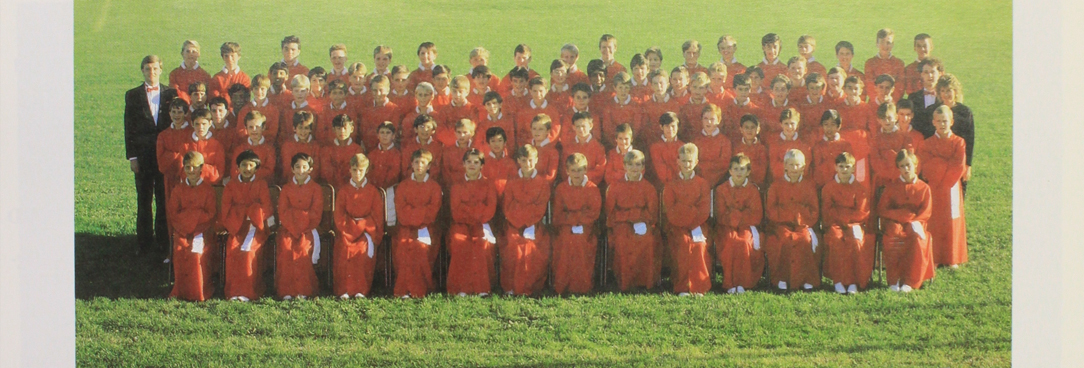 photo of the choir lined up in their red uniforms